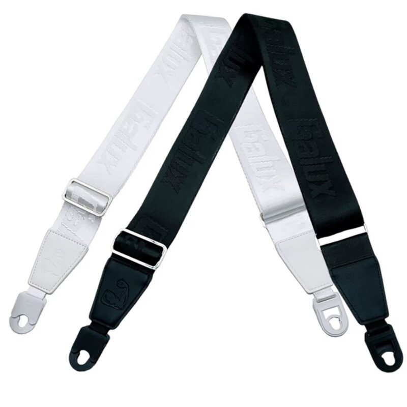 Sangles de guitare Power Grip noire et blanche côte à côte, avec leurs attaches auto-lock